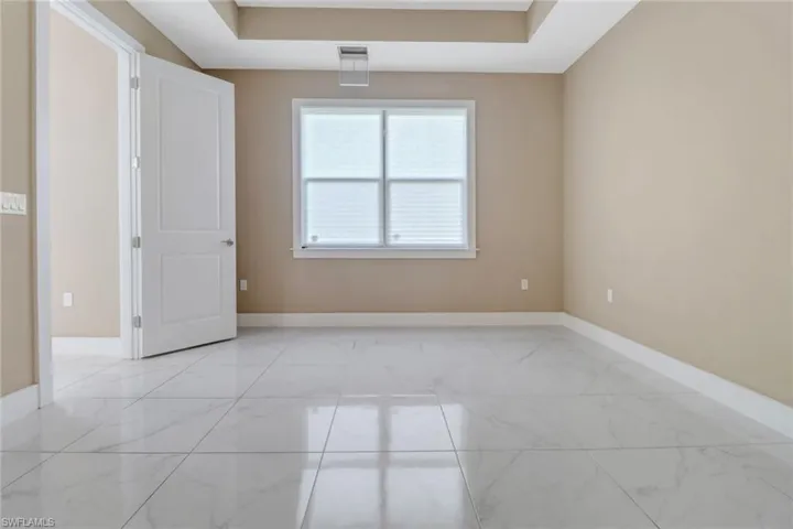 Tiled main bedroom with large windows