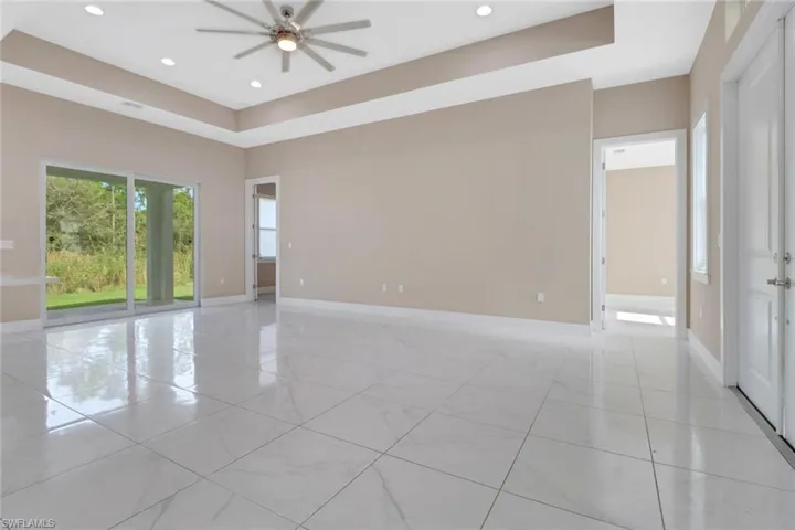 Tiled living room with sliding door to lanai
