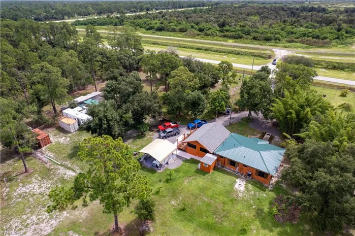 View from above of property featuring a heavily wooded area
