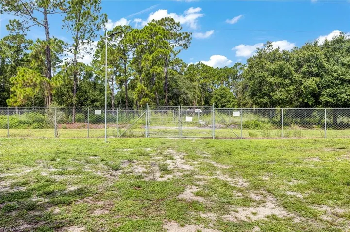 View of back yard with a back  gate