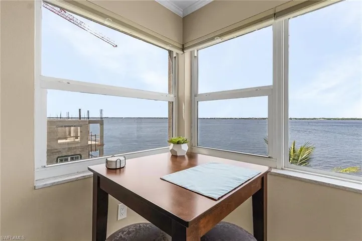 Sunroom / solarium featuring a water view
