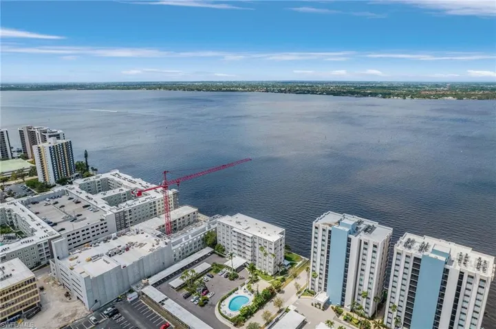 Aerial view featuring a water view and a city view