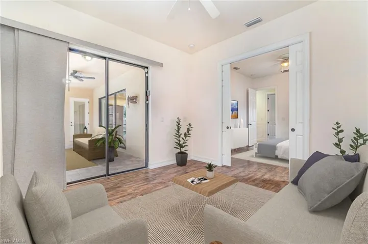 Virtually Staged Primary bedroom #2 sitting room leads to pool area
