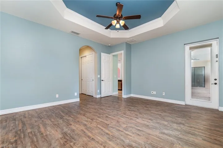Primary Bedroom 1 with door to pool area. 8' doors