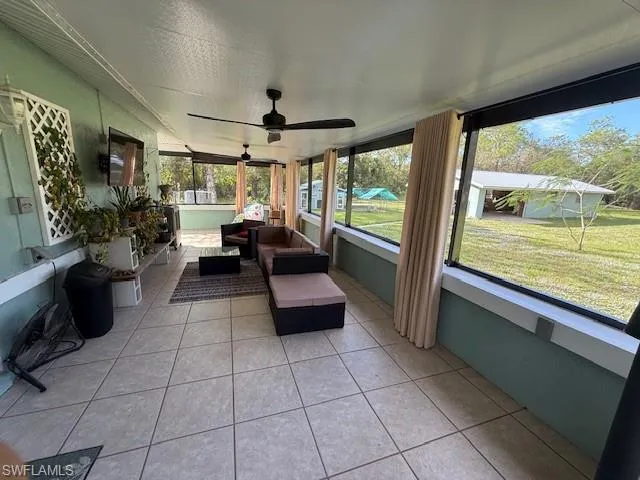 Sunroom featuring ceiling fan