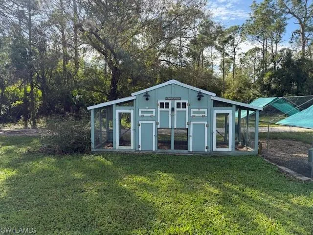 View of outbuilding featuring a yard
