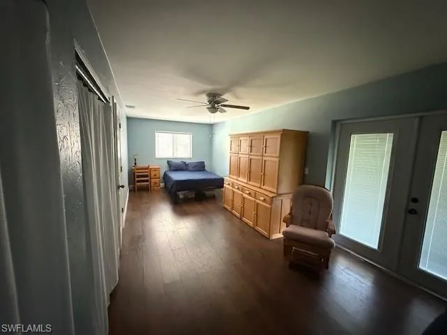 Bedroom with dark hardwood / wood-style flooring and ceiling fan