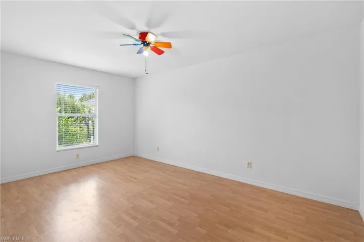 Spare room featuring light wood-style floors and a ceiling fan