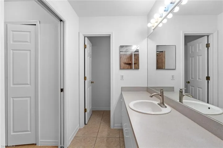 Bathroom with vanity and light tile patterned floors