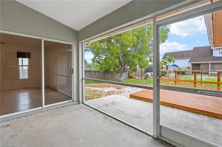 Doorway to outside with concrete flooring and a textured wall