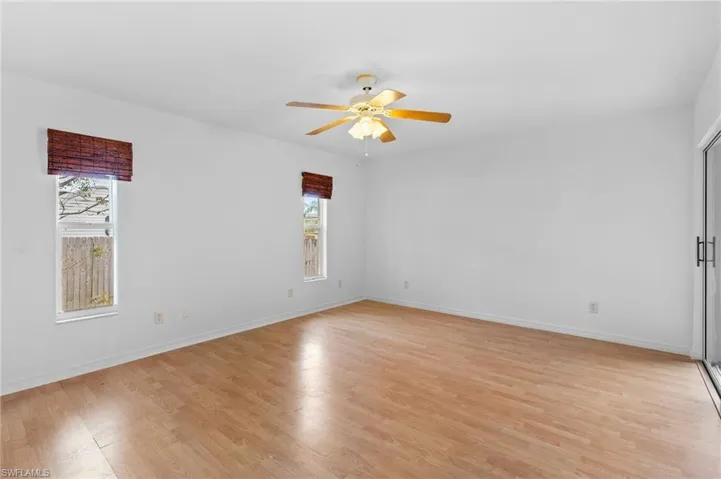 Unfurnished room with light wood finished floors and ceiling fan