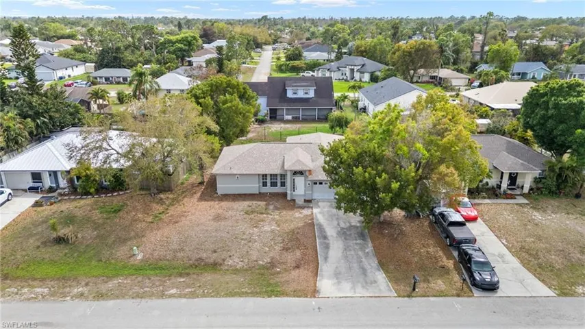 Aerial perspective of suburban area with a tree filled landscape