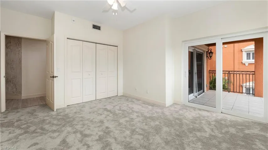 Unfurnished bedroom featuring carpet floors, a closet, access to outside, and ceiling fan