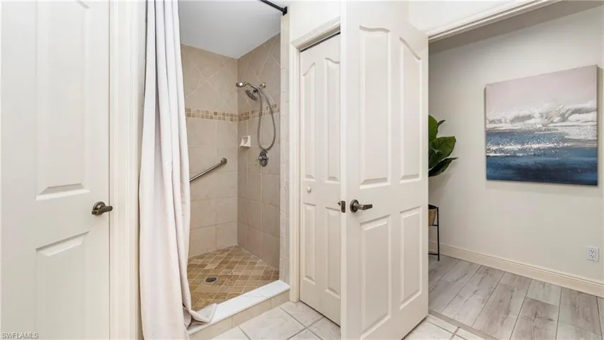 Bathroom with a stall shower and light wood-style flooring