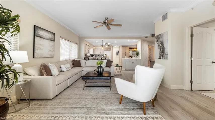 Living area with crown molding, light wood-style flooring, ceiling fan, and recessed lighting