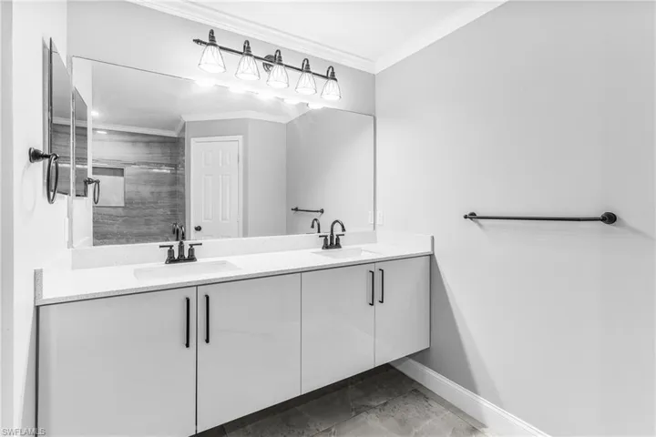 Bathroom with vanity and ornamental molding