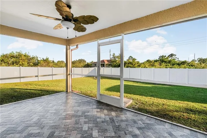 Unfurnished sunroom with ceiling fan