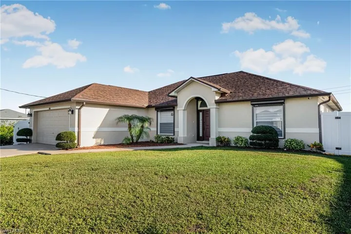 Single story home with a front lawn and a garage