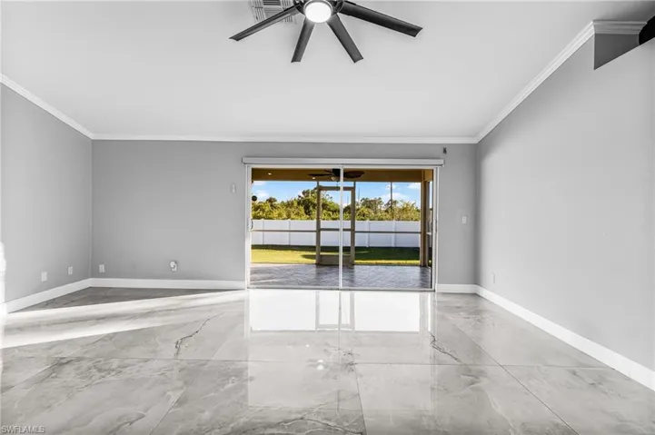 Empty room with ceiling fan and ornamental molding