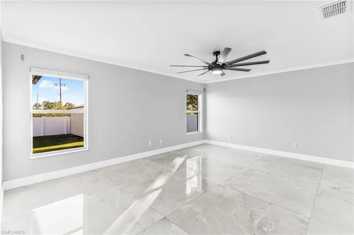 Spare room featuring ceiling fan and ornamental molding