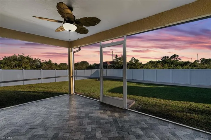 Unfurnished sunroom with ceiling fan