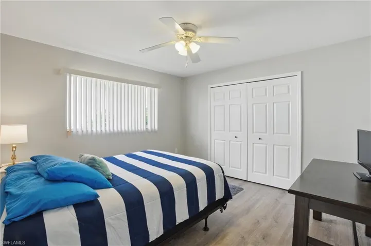 Bedroom featuring wood finished floors, ceiling fan, and a closet