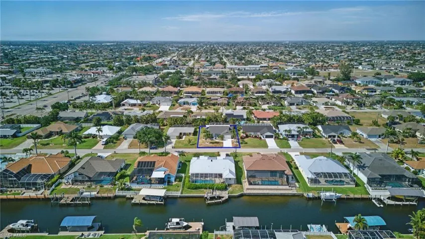 Drone / aerial view with a water view and a residential view