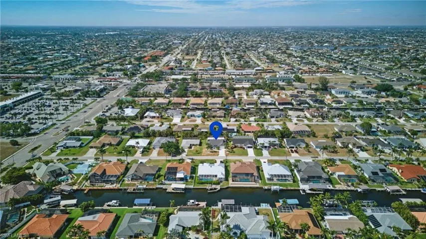 Birds eye view of property with a residential view and a water view