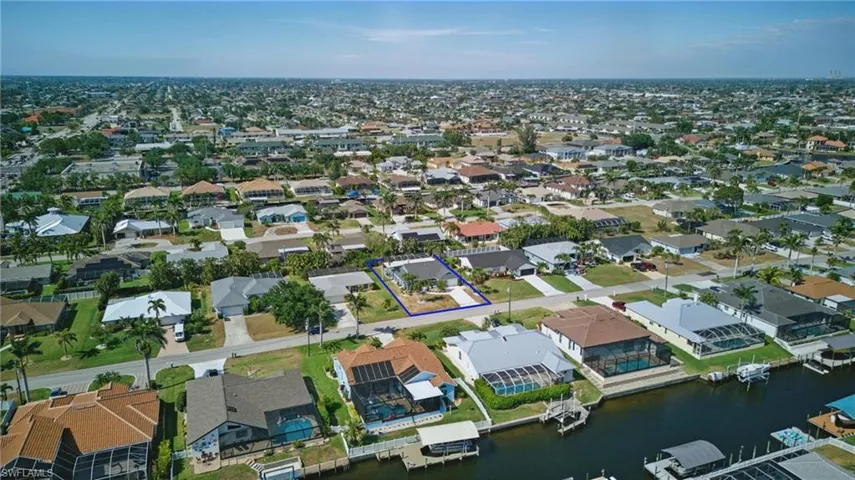 Birds eye view of property with a residential view and a water view