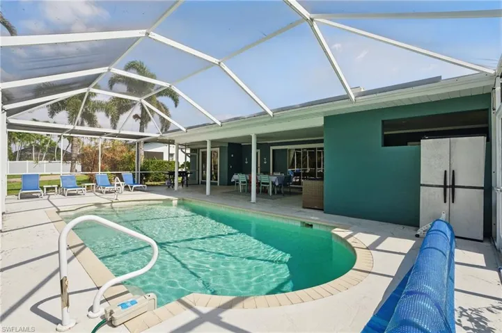 View of pool featuring a lanai, fence, a patio, and a fenced in pool