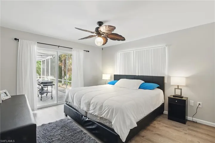 Bedroom featuring baseboards, a ceiling fan, access to exterior, and light wood-type flooring