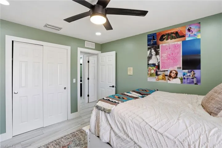 Bedroom featuring light green walls, recessed lighting, and a ceiling fan with integrated lighting