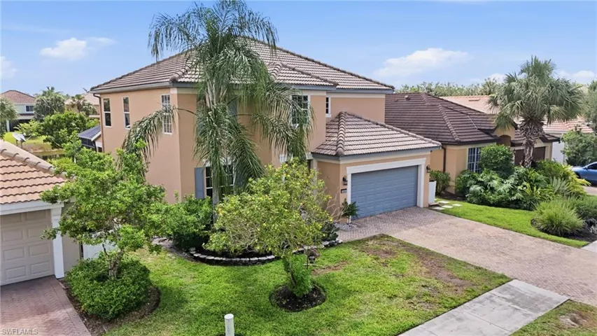 Multi-story stucco exterior featuring a tiled roof, integrated garage, and mature landscaping