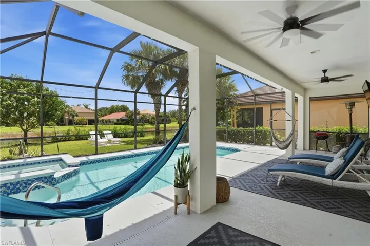 Screened lanai featuring a swimming pool and built-in spa