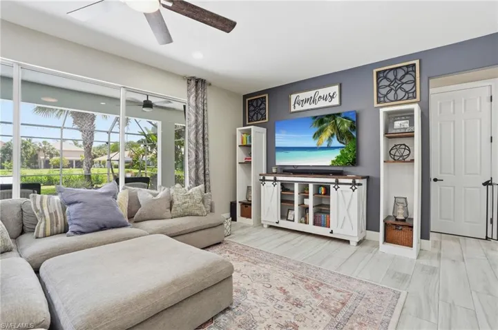 Spacious living area featuring large sliding glass doors opening to a screened patio