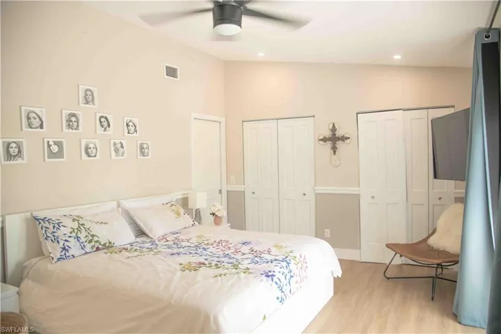 Bedroom with multiple closets, light wood-style flooring, recessed lighting, and a ceiling fan