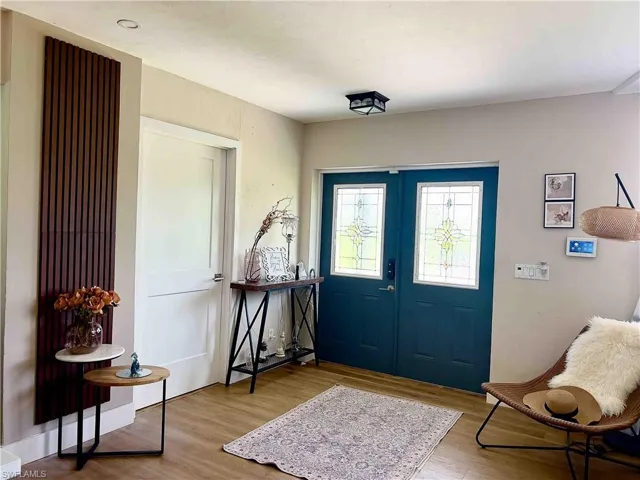 Foyer entrance featuring wood finished floors