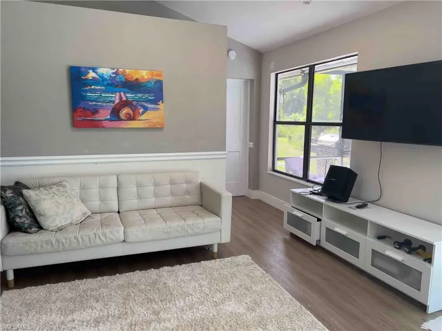 Living room with wood finished floors and baseboards