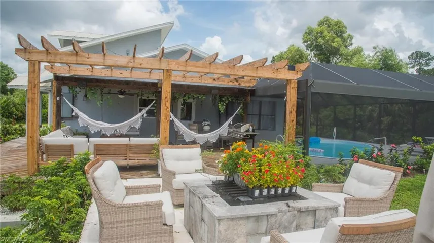 View of patio with outdoor lounge area, an outdoor pool, a lanai, and a pergola