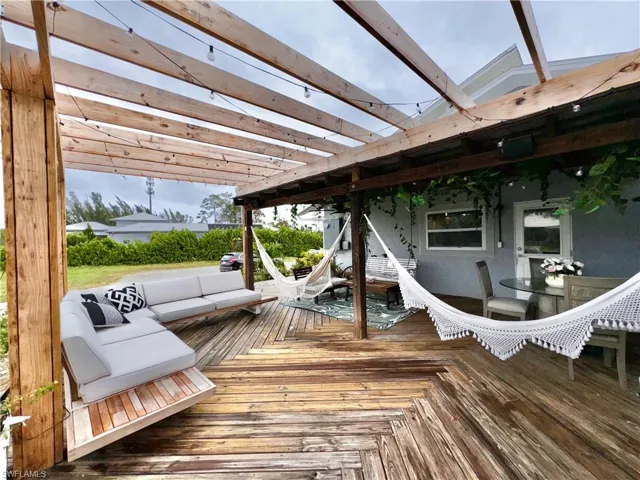 Deck with a pergola and an outdoor living space