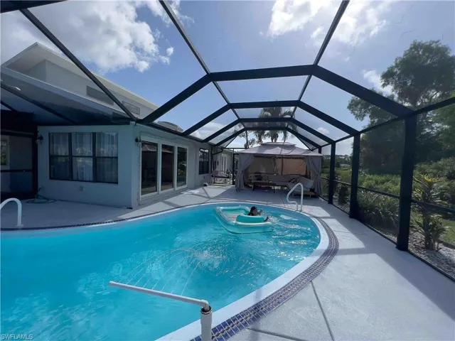 Outdoor pool featuring a patio and a lanai