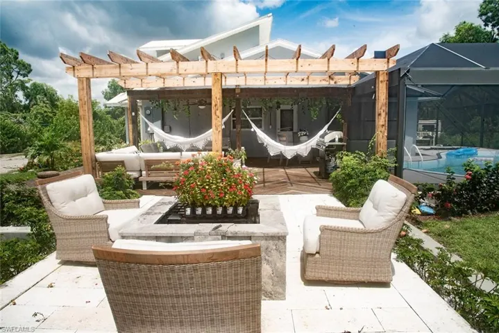 View of patio with outdoor lounge area, an outdoor pool, a pergola, a lanai, and grilling area