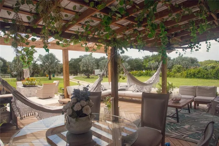 View of patio with an outdoor living space, a pergola, outdoor dining space, and a wooden deck