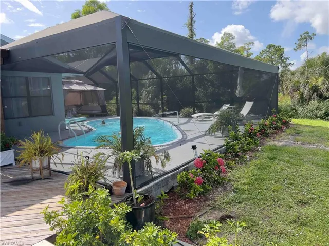 Swimming pool with a deck, a lanai, and a patio area