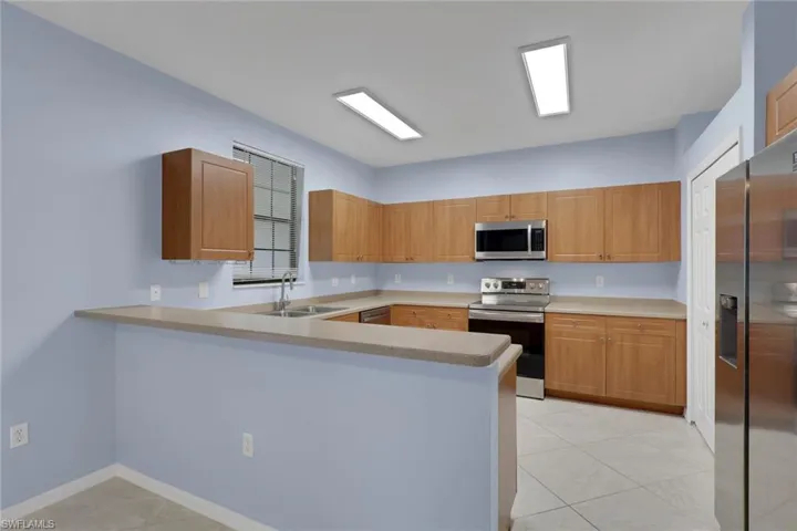 Stainless steel appliances including a refrigerator, range, and microwave