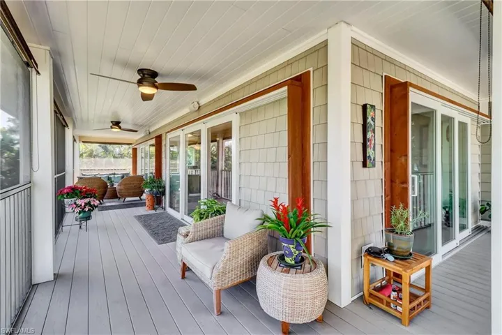 Deck with a sunroom and a ceiling fan