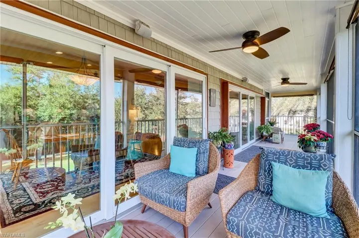 Sunroom with a ceiling fan and an outdoor living space