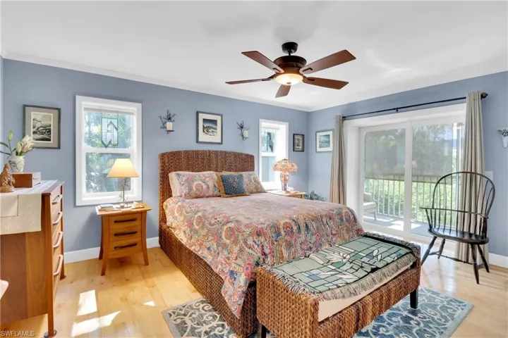 Bedroom with access to outside, light wood-type flooring, ceiling fan, and ornamental molding