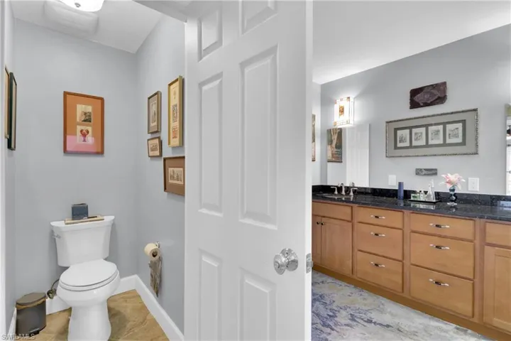Bathroom featuring double vanity and toilet