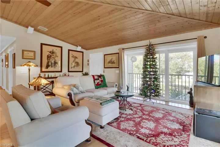 Living area featuring wooden ceiling and vaulted ceiling